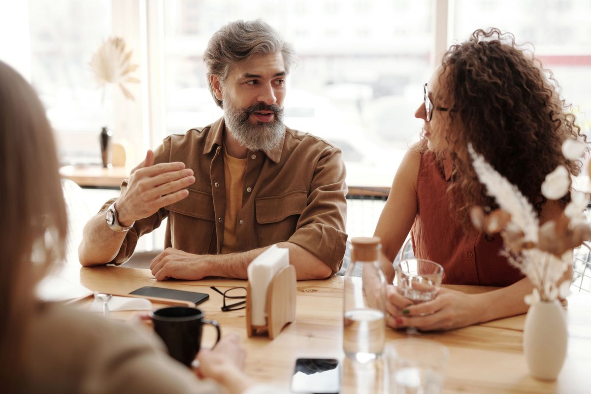 Two people in conversation at a cafe table